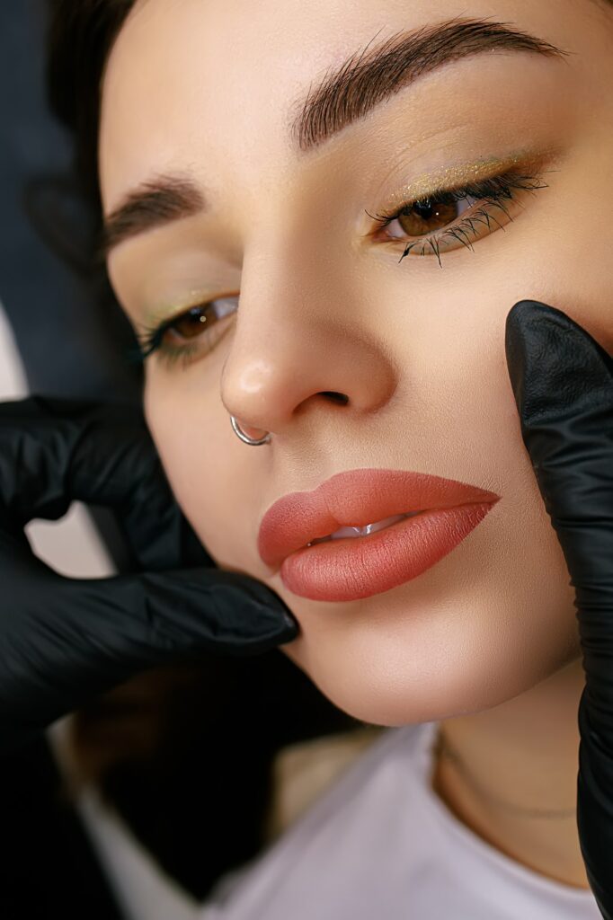 Beautiful lips of a girl with a permanent make-up of the lips close-up. Lip tattoo matte effect.